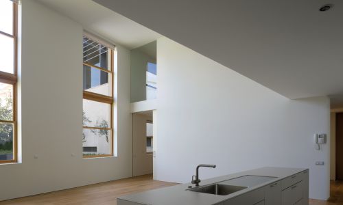 Lofts en Fabrica de Sabadell en Barcelona Diseño interior de cocina y salón a doble altura de Cruz y Ortiz Arquitectos